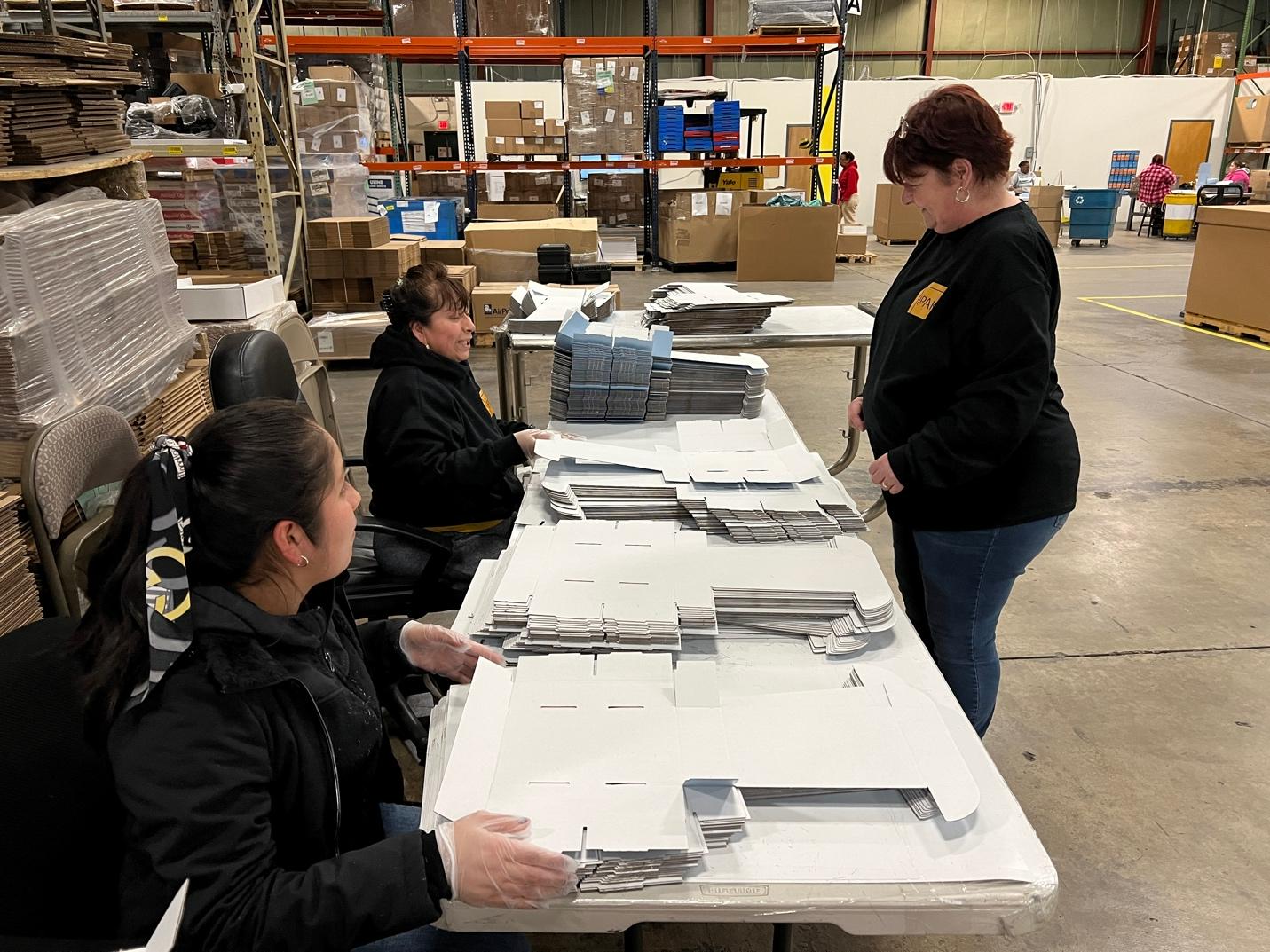 Employees packaging boxes