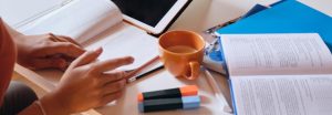Coffee cup and work materials on a desk