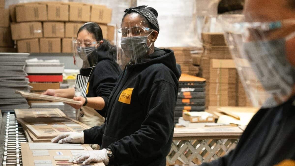 employee in face shield and mask