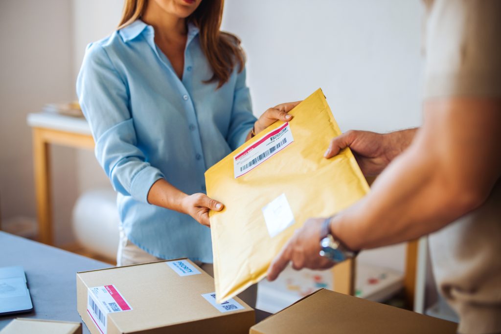 People Exchanging Package in an Office Setting