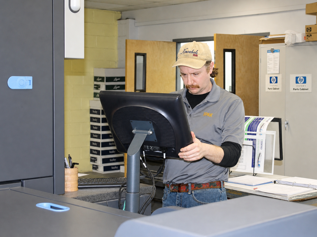 Man on monitor at print center
