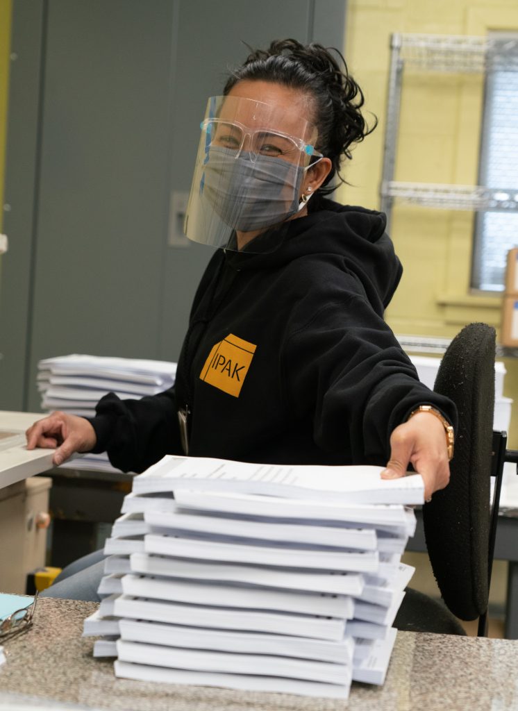Worker wearing protective mask, goggles and faceshield